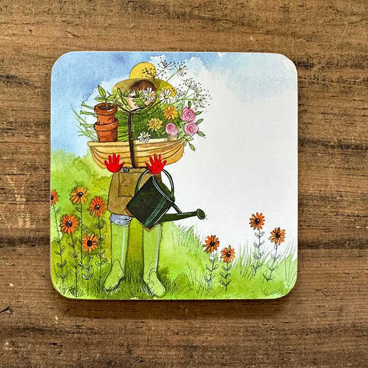 Coaster with a garden-themed illustration of a person holding flowers and a watering can on a wooden surface.
